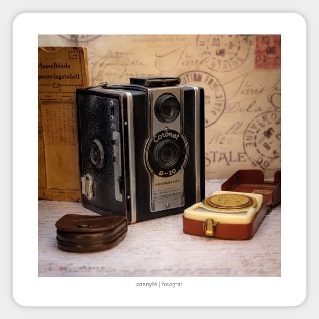 An old vintage camera with external exposure meter, as a poster Sticker by connyM-Sweden